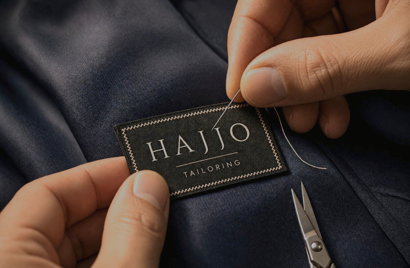 The Hajjo Tailoring label being stitched into a jacket lining